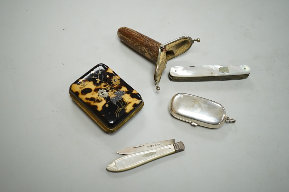 A George V engine turned silver mounted rectangular cigarette box, Birmingham, 1923, 17.7cm, a sterling mounted pepper grinder, four weighted sterling condiments and a small plated tray.
